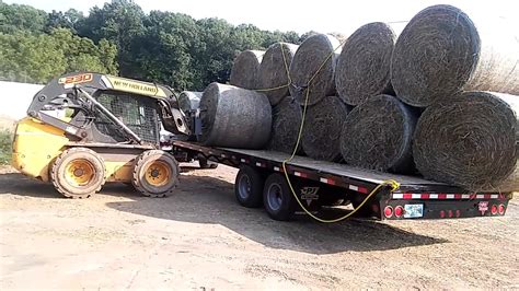 using a skid steer for hay making|round bales skid steer.